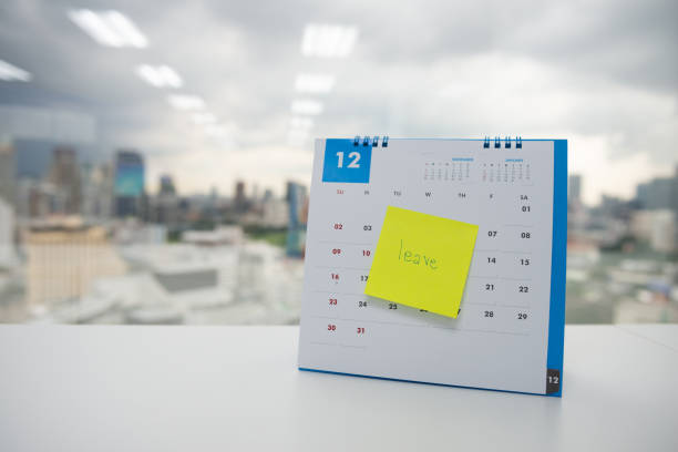 Leave on paper note stick on the calendar of December for year end holidays concept Leave on paper note stick on the calendar of December for year end holidays concept workplace absence stock pictures, royalty-free photos & images