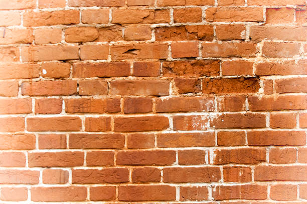 istock Texture, background, pattern. An old cement stone wall as vintage cracked, worn and worn out creative poster design. Cracks, scrapes, peeling old paint and plaster on the background of old cement wall 1068642520