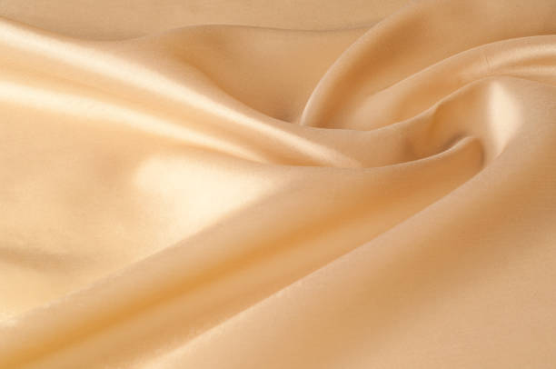 istock Texture background of fabric. Beige fabric. Silk fabric wallpaper texture background pattern in sepia pastel yellow cream beige tint: Lovely natural silk textured textile 1068642558