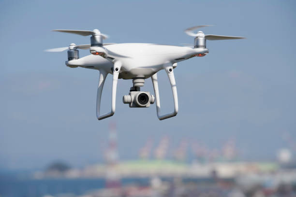 White drone flying over the city Kagawa, Japan - October 25, 2018: White drone with high resolution digital camera flying above the Tadotu-city, Kagawa. Take-off or landing quadcopter. drone point of view stock pictures, royalty-free photos & images