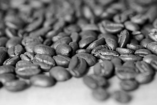 istock Roasted coffee beans on a wooden background. Black and white 1068643014