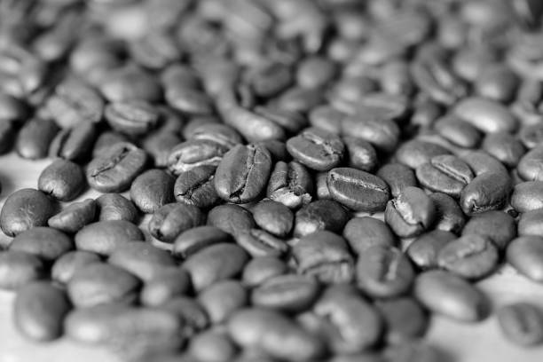 istock Roasted coffee beans on a wooden background. Black and white 1068643042