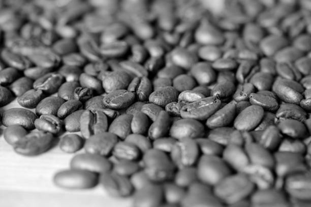 istock Roasted coffee beans on a wooden background. Black and white 1068643044