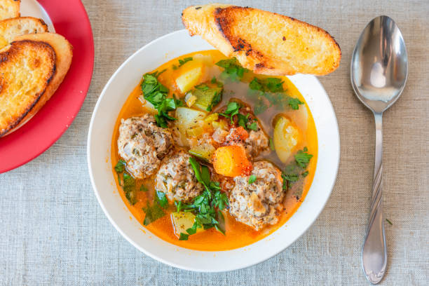istock Mexican soup with meatballs and vegetables in a plate on a rustic background - Albondigas 1068651172