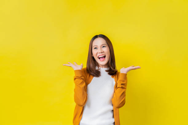 istock Asian girl is surprised she is excited.Yellow background studio 1068663908