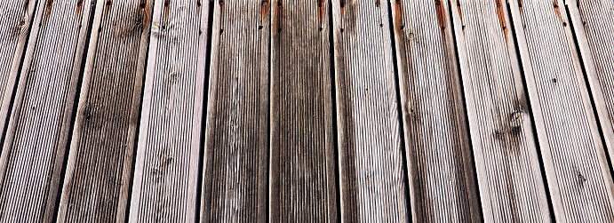 Close up view of composite decking. Wooden floorboards for background backdrop use.