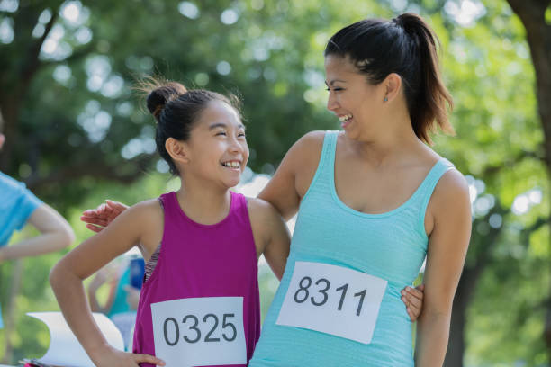 istock Asian mother and daughter pose together during a marathon 1068668442