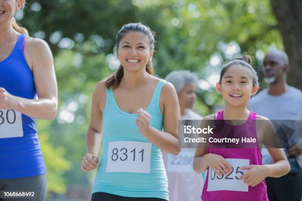 Asian Mother And Daughter Run Together In A Marathon Stock Photo - Download Image Now