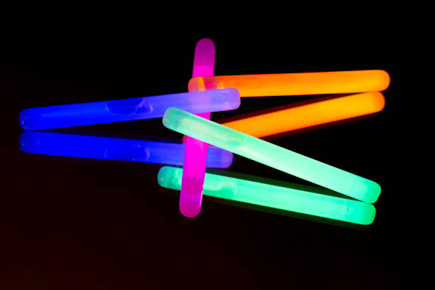 istock 17/11/2018Colorful fluorescent light neon big glow stick on mirror reflection black background 1068674780