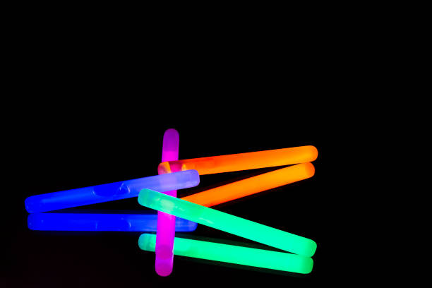 istock Colorful fluorescent light neon big glow stick on mirror reflection black background 1068675540