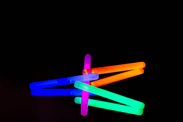 istock Colorful fluorescent light neon big glow stick on mirror reflection black background 1068679316