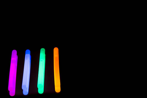Colorful fluorescent light neon big glow stick on mirror reflection black background