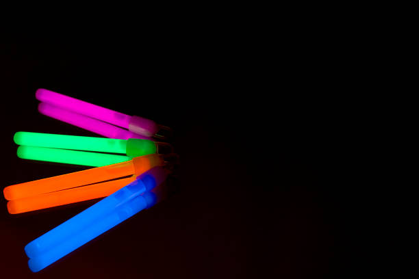 istock Colorful fluorescent light neon big glow stick on mirror reflection black background 1068685138