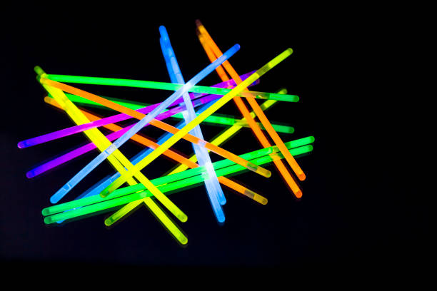 istock Colorful fluorescent light neon big glow stick on mirror reflection black background 1068687342