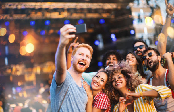 istock People taking selfie at concert. 1068690836