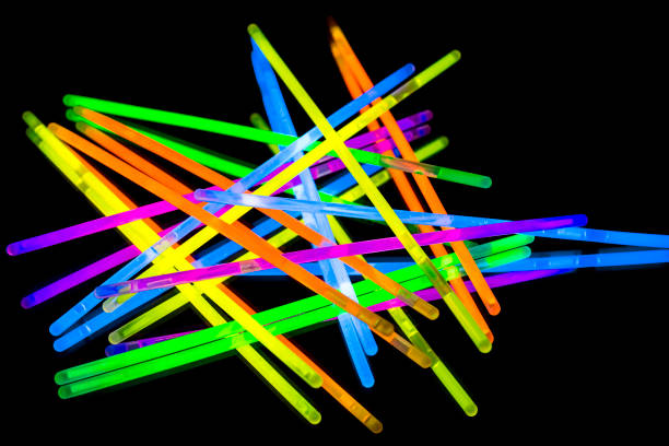istock Colorful fluorescent light neon big glow stick on mirror reflection black background 1068691184