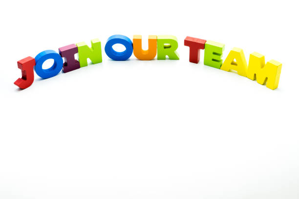 istock Join Our Team text written with colourful wooden letters, isolated over white with copy space on the bottom. 1068692776