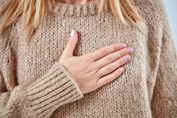 istock Young woman with heart problem holding chest. 1068694742