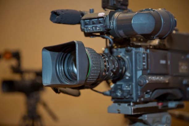 istock Professional video camera set on a tripod with excellent clipping path . Professional production video camera. video camera in business conference room recording participants 1068694780