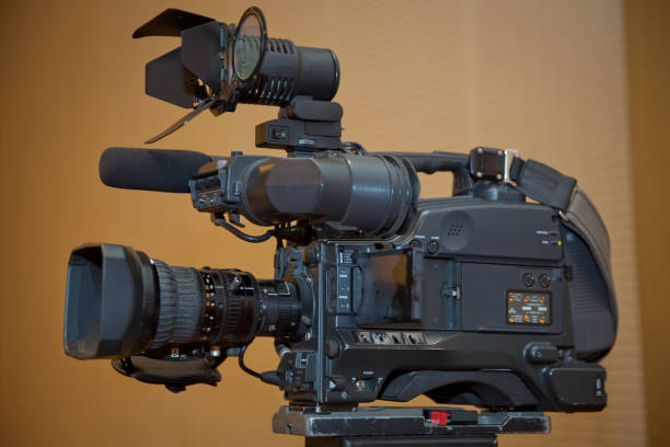 istock Professional video camera set on a tripod with excellent clipping path . Professional production video camera. video camera in business conference room recording participants 1068694804