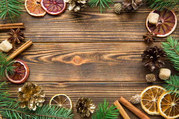 istock Dried sicilian oranges wuth cinnamon sticks, anise and golden cones. Space for text. 1068694982