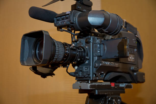 istock Professional video camera set on a tripod with excellent clipping path . Professional production video camera. 1068695092