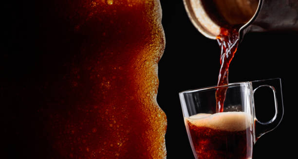 istock Small cup of coffee on a black background. 1068695294