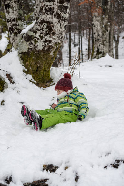 istock Young boy having fun lying in the snow 1068703442