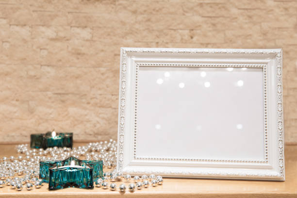 istock Mock up christmas decoration. New Year greeting frame. Turquoise stars-shaped candlesticks, glittering silver glass beads, snowflake decoration. Brick walls, space for text. 1068704120