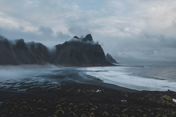 Aerial view of Vestrahorn mountains near the sea Aerial view of Vestrahorn mountains near the sea in Iceland black sand stock pictures, royalty-free photos & images