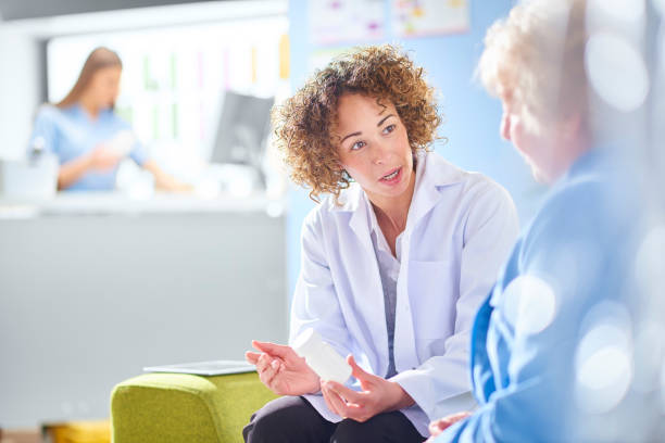 istock pharmacist discussing medication with senior customer 1068721716