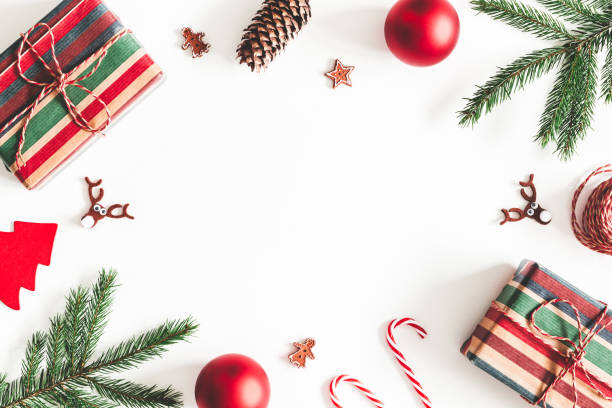 istock Christmas composition. Christmas gifts, fir tree branches, decorations on white background. Flat lay, top view, copy space 1068722226