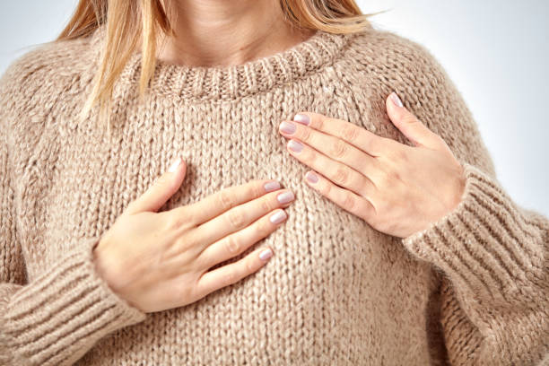 istock Young woman with heart problem holding chest. 1068722438