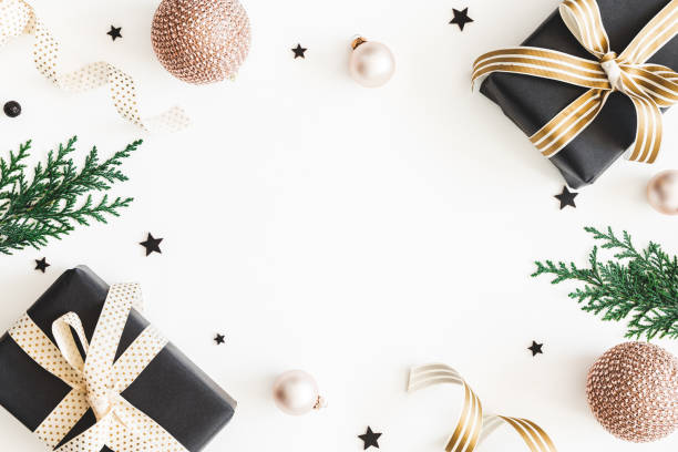 istock Christmas composition. Gifts, fir tree branches, black and golden decorations on white background. Christmas, winter, new year concept. Flat lay, top view, copy space 1068723774