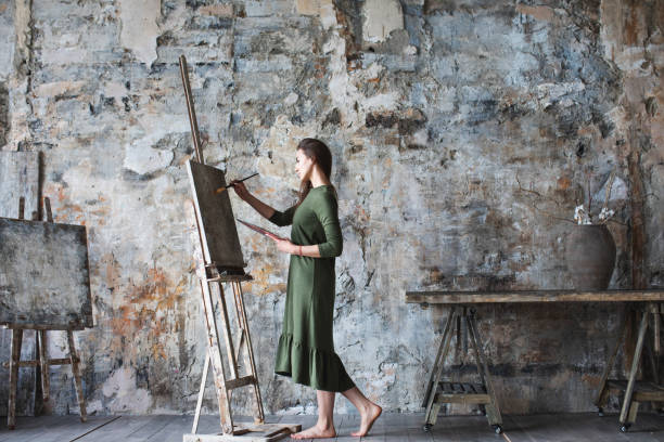 istock Woman painter in a green dress 1068732910