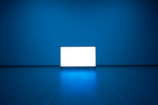 The television on the floor with a blue light background stock photo