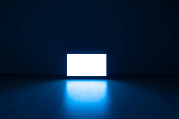 The television on a floor with a blue light background stock photo