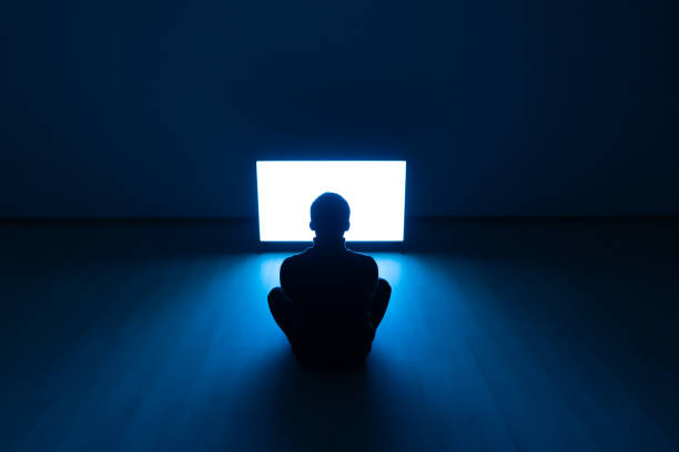 istock The man sitting on the floor and watching the television 1068733072