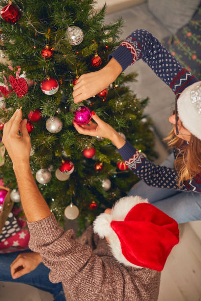 istock Happy couple decorating tree for New Year's / Christmas eve. 1068734578