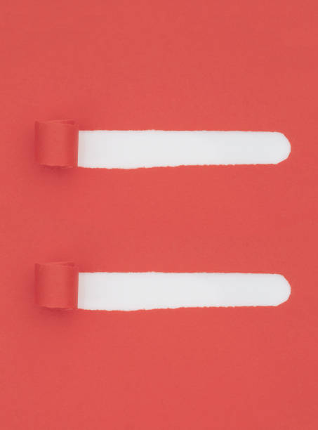 istock Torn, ripped red paper with white underneath, curled and rolled. Two strips removed to leave holes. Background. 1068737296