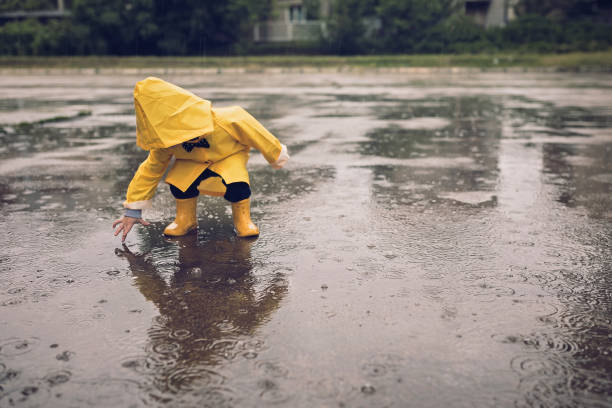 istock Boy playing outdoors at rainy autumn day 1068739576