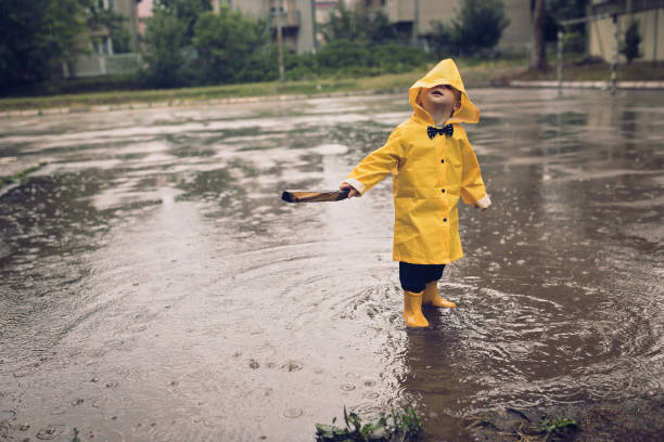 istock Cute little boy playing outdoors at rainy autumn day 1068742950