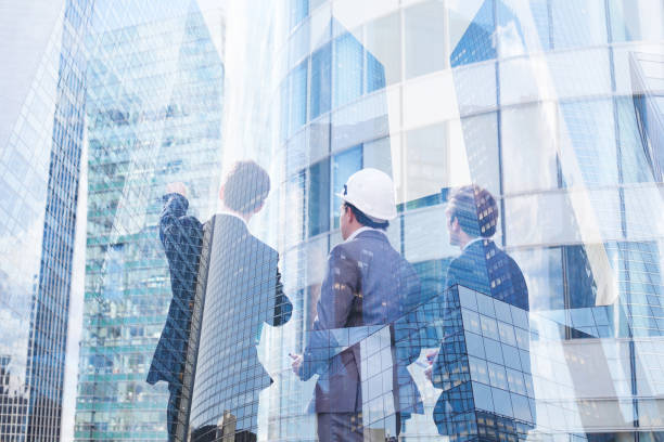 group of business people discussing real estate project, double exposure - engineer architect building contractor team imagens e fotografias de stock