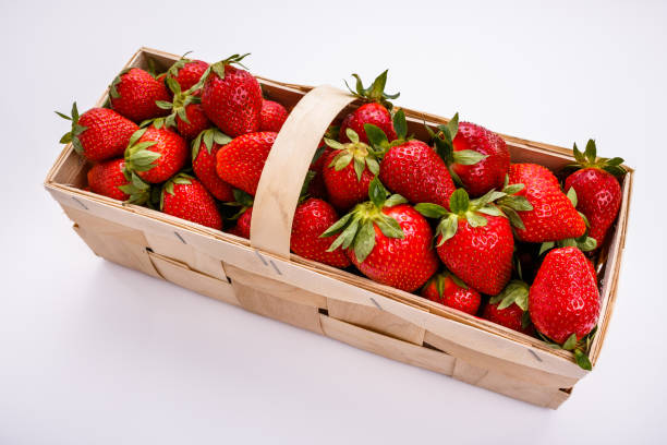 istock Juicy fresh strawberries in a wooden basket 1068753076