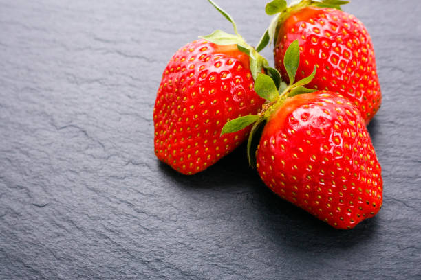 istock juicy fresh strawberry on a dark stone background 1068753232