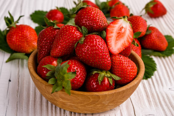 istock Juicy fresh strawberry on a rustic wooden background 1068755492