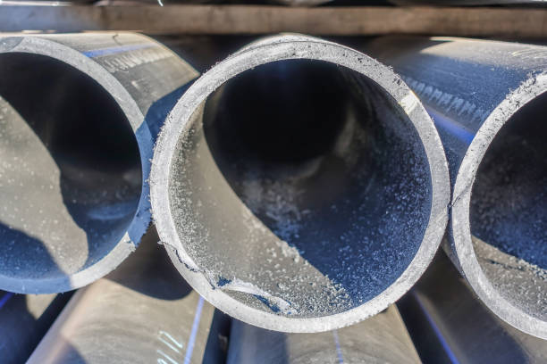 istock Stacks of black plastic pipes. Round ends close up. 1068755630