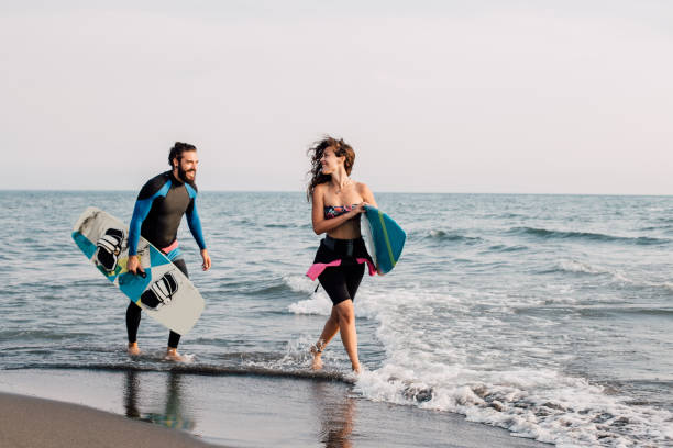 istock Surfers running at the beach 1068758374