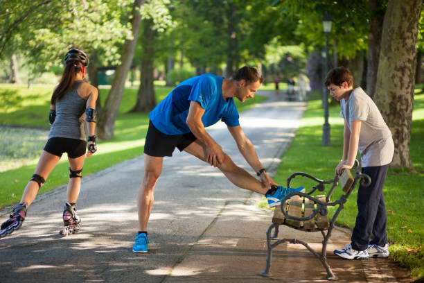 istock Father and son stretching on park bench 1068760584