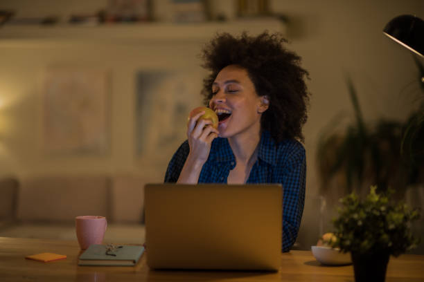 istock Young woman eating an apple 1068760822